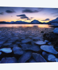 Ice Flakes Drifting Against The Sunset In Tjeldsundet Strait, Troms County, Norway